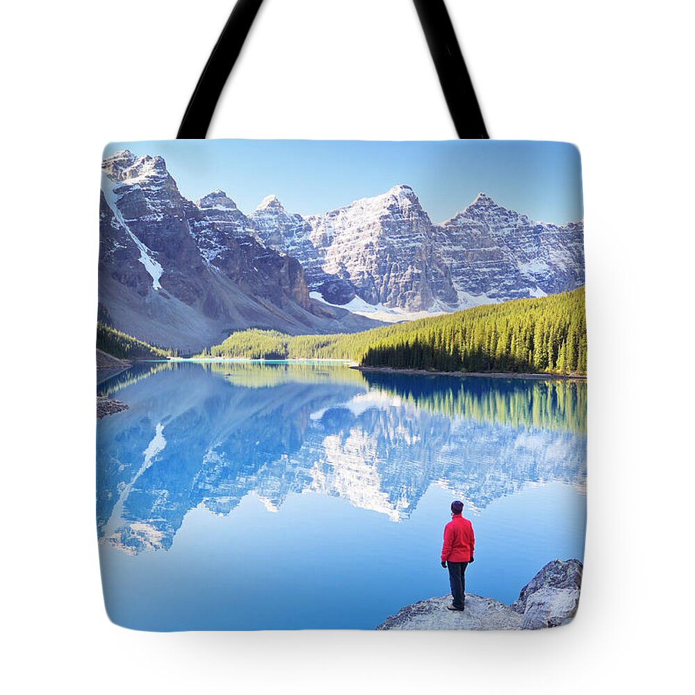 Moraine Lake Tote Bag featuring the photograph Lone hiker at Moraine Lake, Canadian Rockies by Neale And Judith Clark