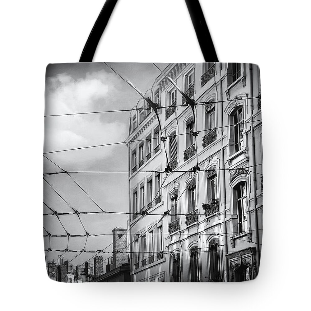 Lyon Tote Bag featuring the photograph Lyon France Through a Web of Tram Lines Black and White by Carol Japp