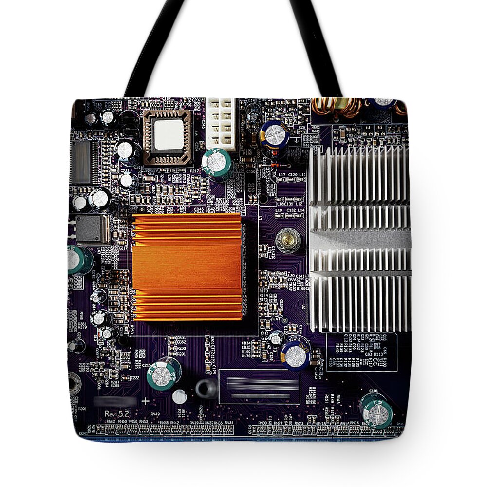 Computer Tote Bag featuring the photograph Mainboard of a pc with electronic components. by Bernhard Schaffer