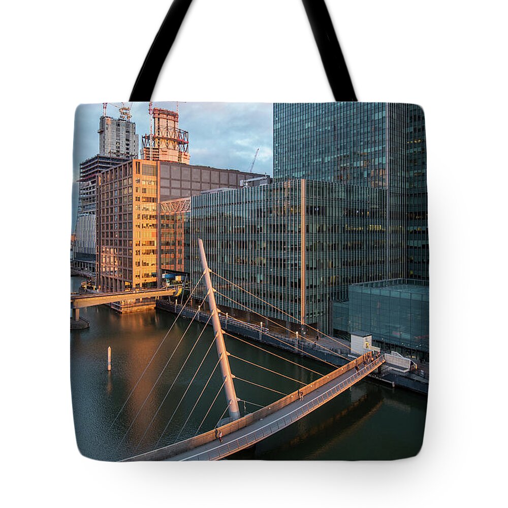 Canary Wharf Tote Bag featuring the photograph Modern office building in the Canary Wharf financial centre in the evening. London united kingdom by Michalakis Ppalis