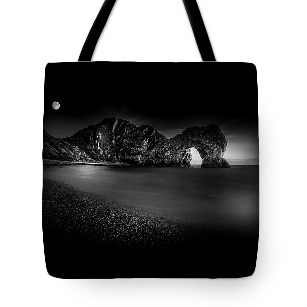 Black Tote Bag featuring the photograph Moon over Durdle Door by Chris Boulton