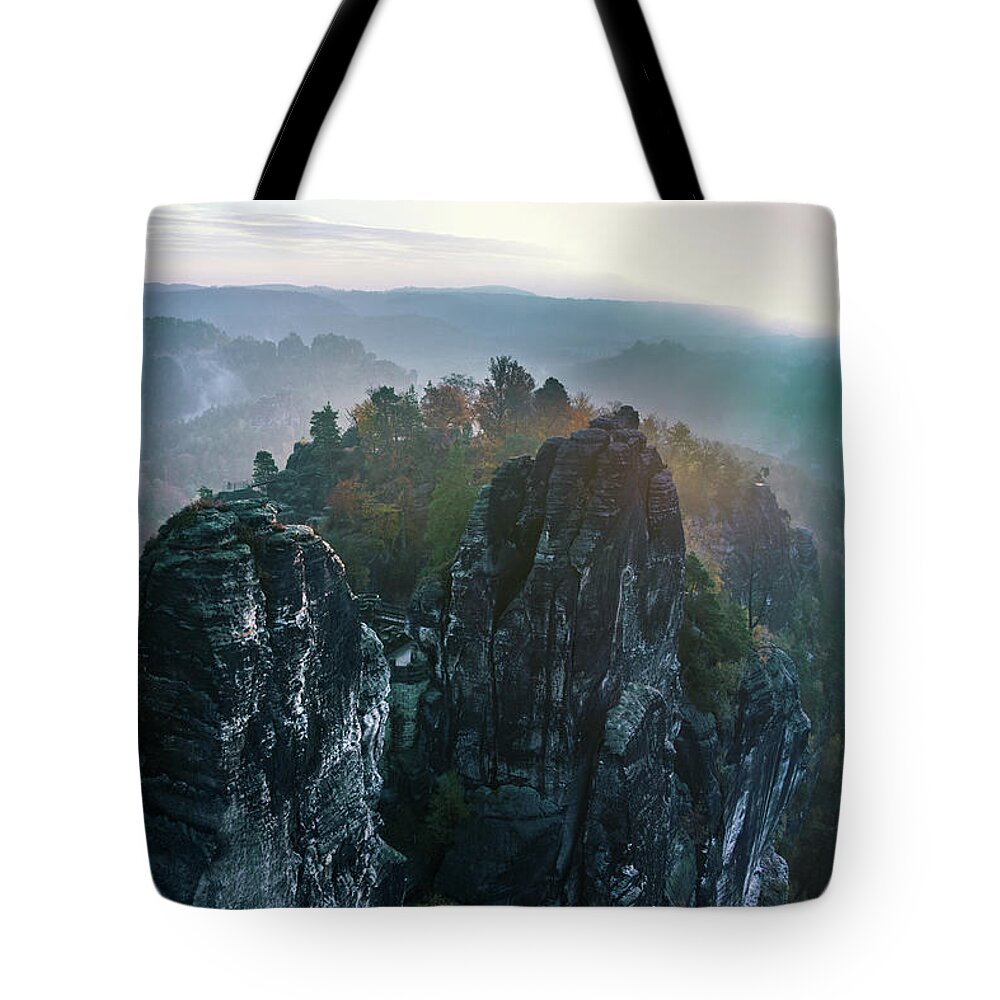 Saxon Switzerland Tote Bag featuring the photograph Morning mist on the Bastei rocks in Saxon Switzerland by Sun Travels