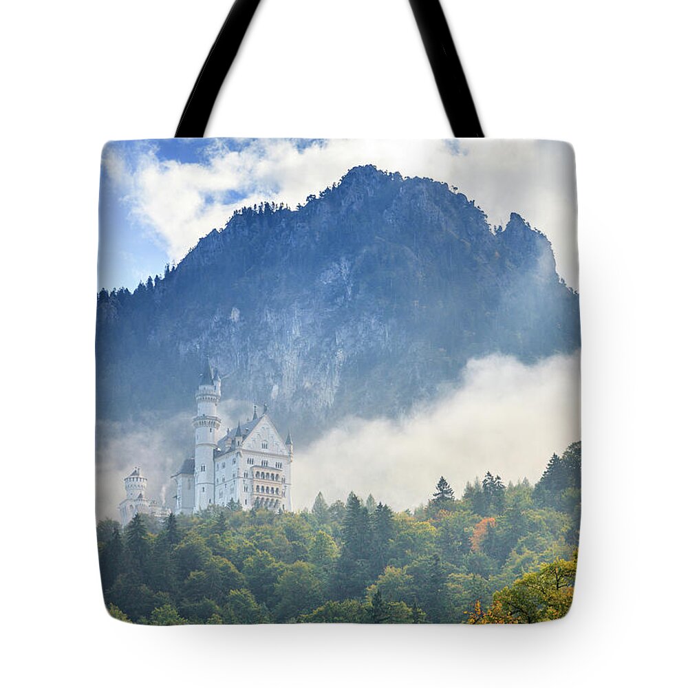 Alps Tote Bag featuring the photograph Neuschwanstein Castle in morning fog by Alexey Stiop