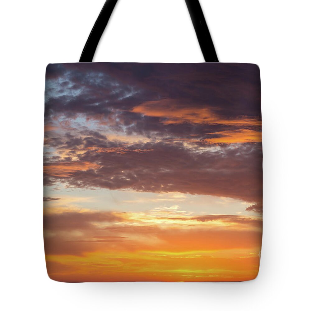Clouds Tote Bag featuring the photograph Orange glowing sunrise by Adriana Mueller