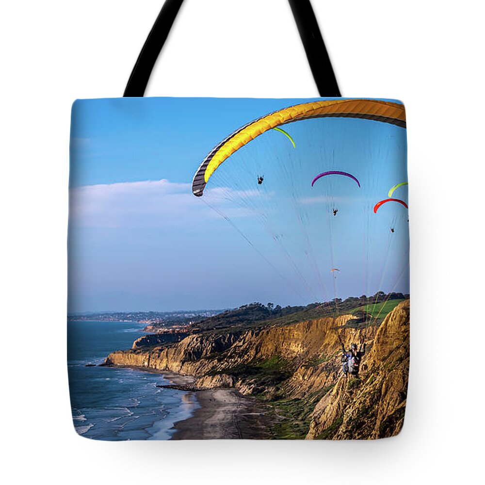 Beach Tote Bag featuring the photograph Paragliders Flying Over Torrey Pines by David Levin