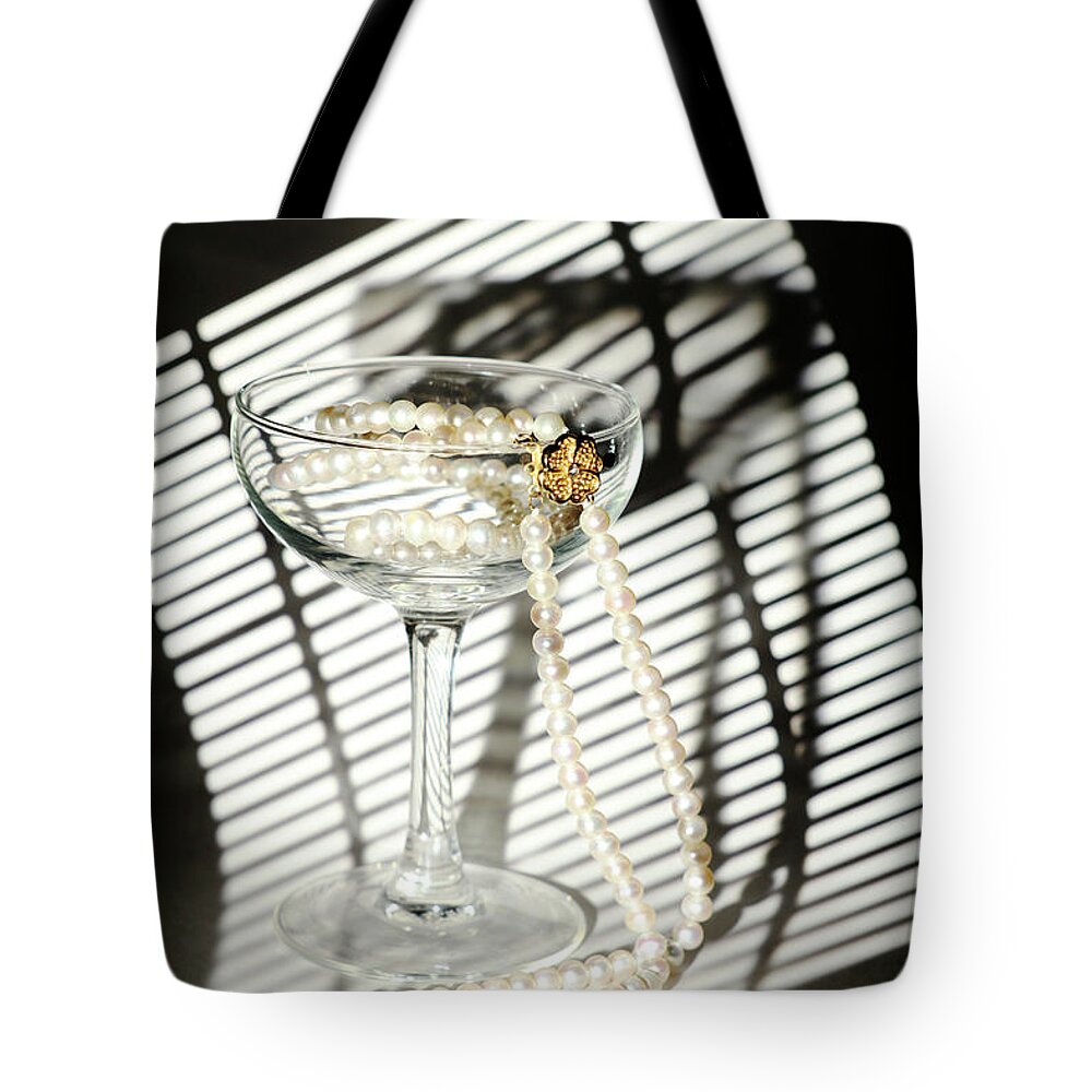 Russian Artists New Wave Tote Bag featuring the photograph Pearls Necklace in Wineglass by Dmitry Soloviev