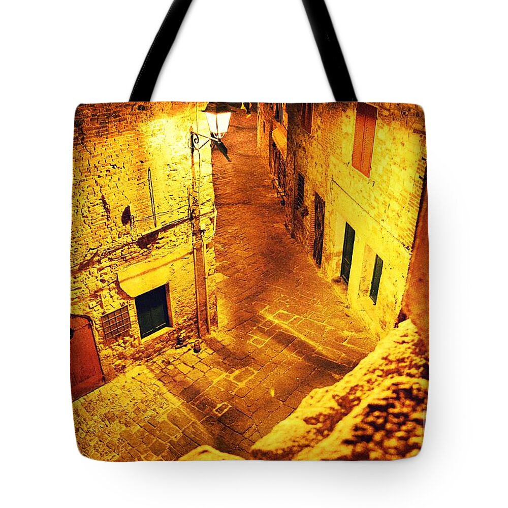 Golden Tote Bag featuring the photograph Piazza by night in Tuscany by Ramona Matei