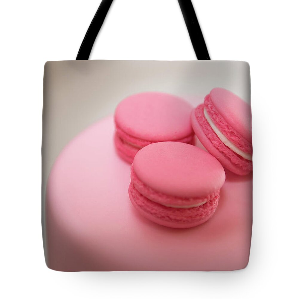 Macaroon Tote Bag featuring the photograph Pink color french delicious macaroons cookies. Shallow dof by Michalakis Ppalis