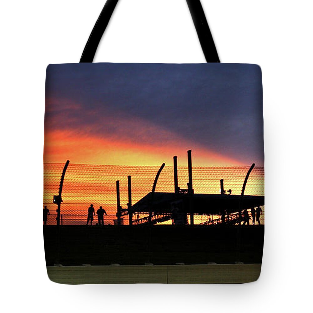 Race Tote Bag featuring the photograph Race Fans silhouetted against Sunset by Pete Klinger