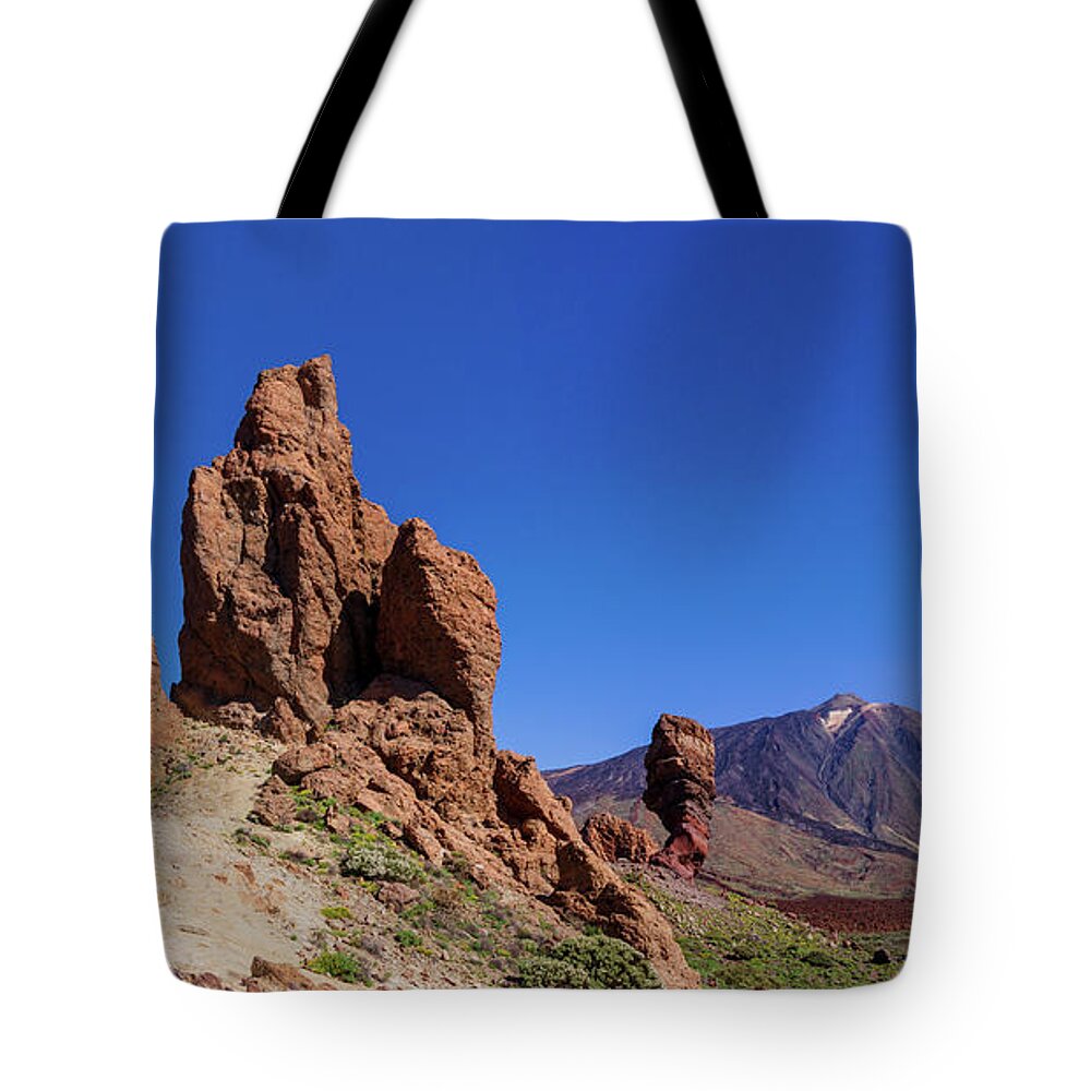 Mountains Tote Bag featuring the photograph Red rocks in front of Mount Teide by Sun Travels
