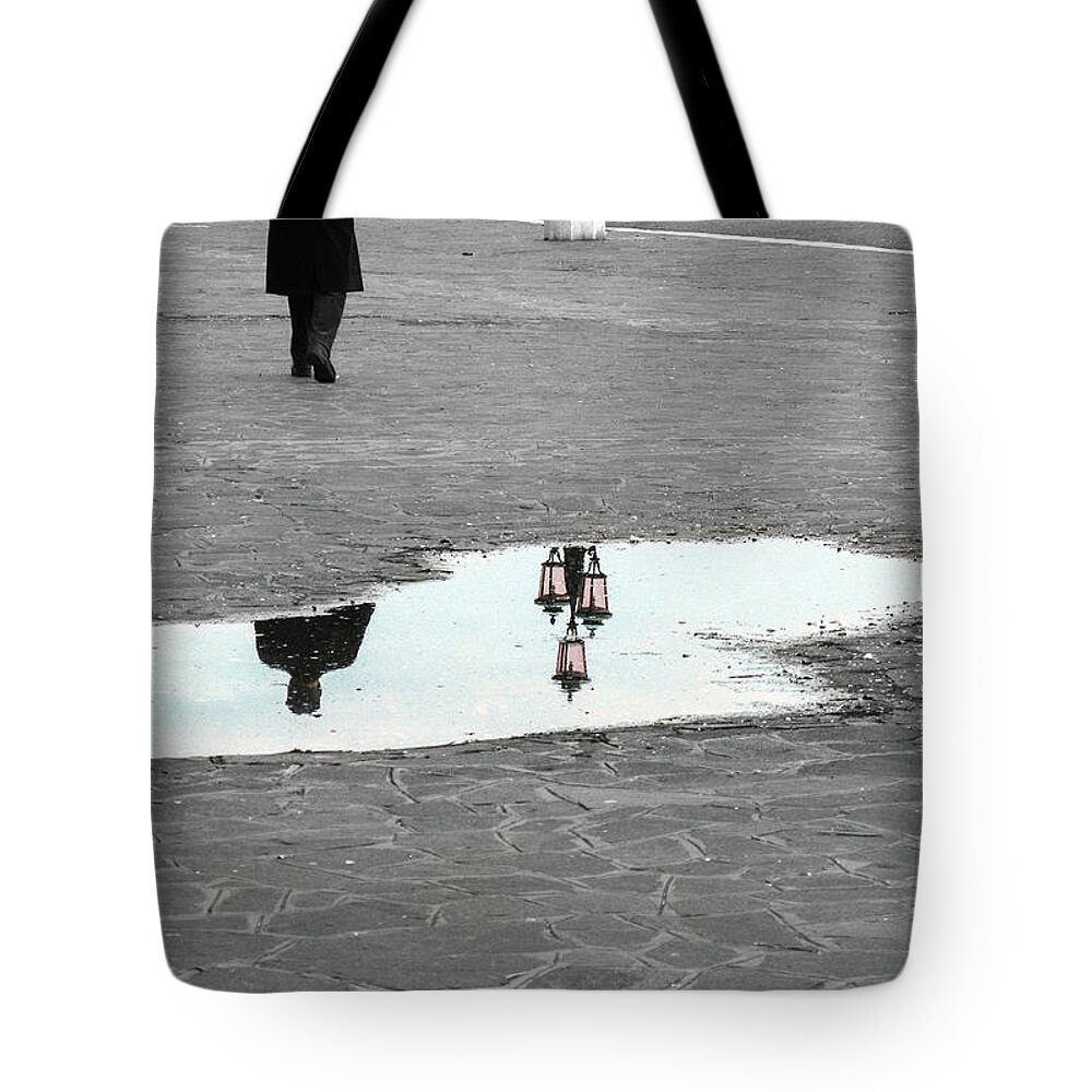 Puddle Tote Bag featuring the photograph Reflection of a man in a puddle by Fabiano Di Paolo