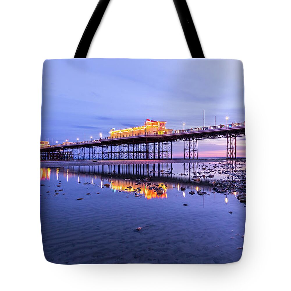 Beach Tote Bag featuring the photograph Reflection of the pier at sunset by Andrew Lalchan