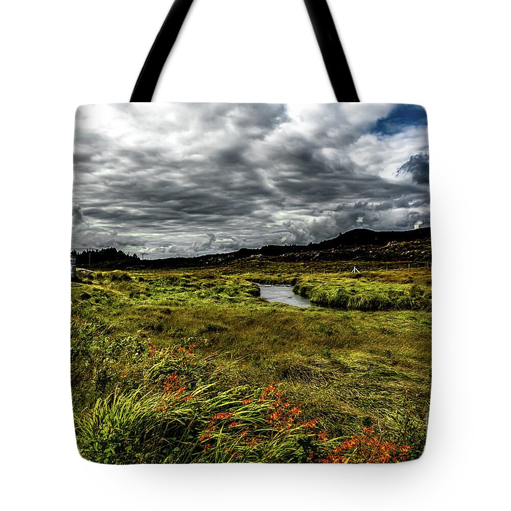 Ireland Tote Bag featuring the photograph Remote Hut Beneath River in Ireland by Andreas Berthold