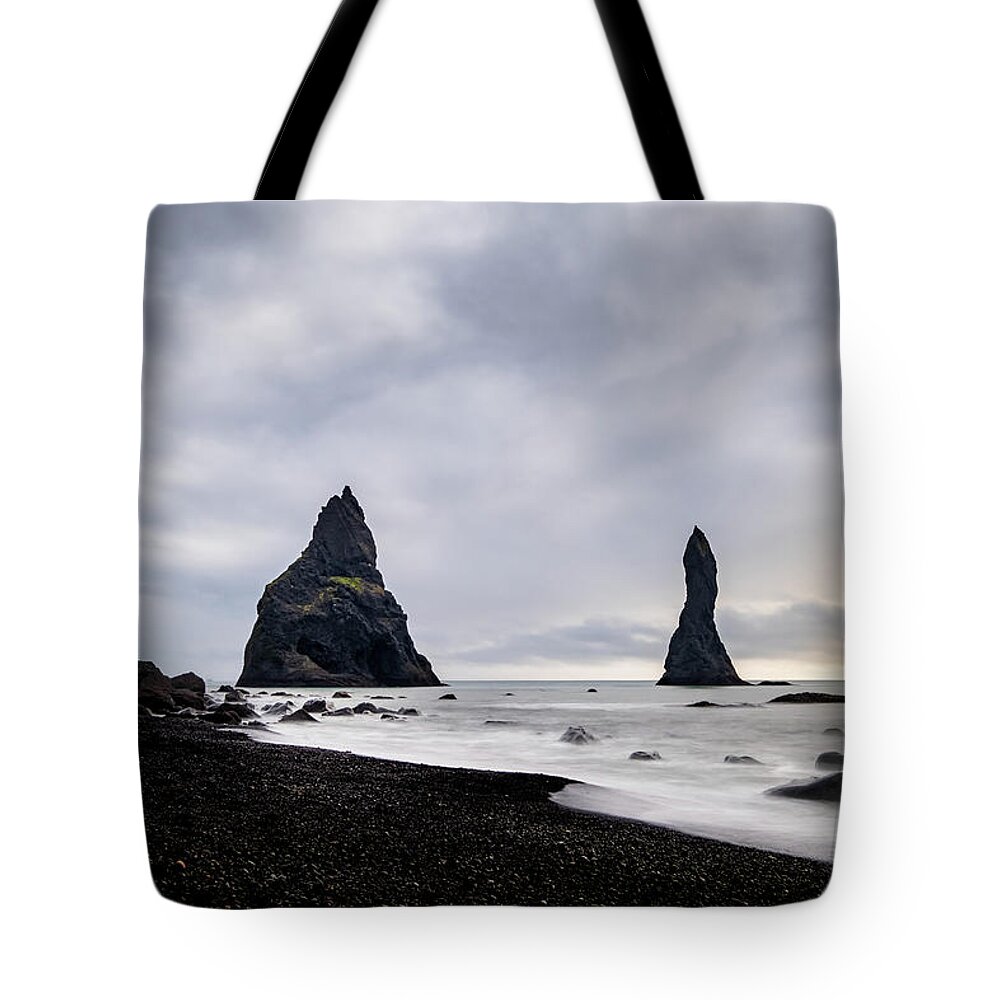Reynisfjara Tote Bag featuring the photograph Reynisfjara black sand beach and Reynisdrangar in Iceland by Alexios Ntounas