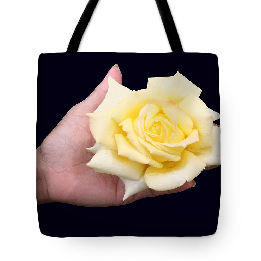 Roses Tote Bag featuring the photograph Rose in the hand by Christopher Rowlands