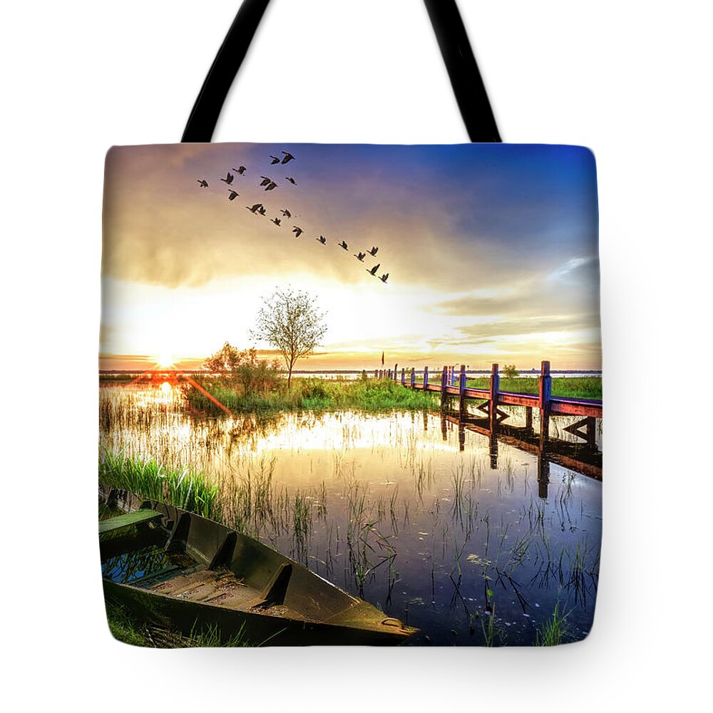 Birds Tote Bag featuring the photograph Rowboat in the Marsh at Sunset by Debra and Dave Vanderlaan