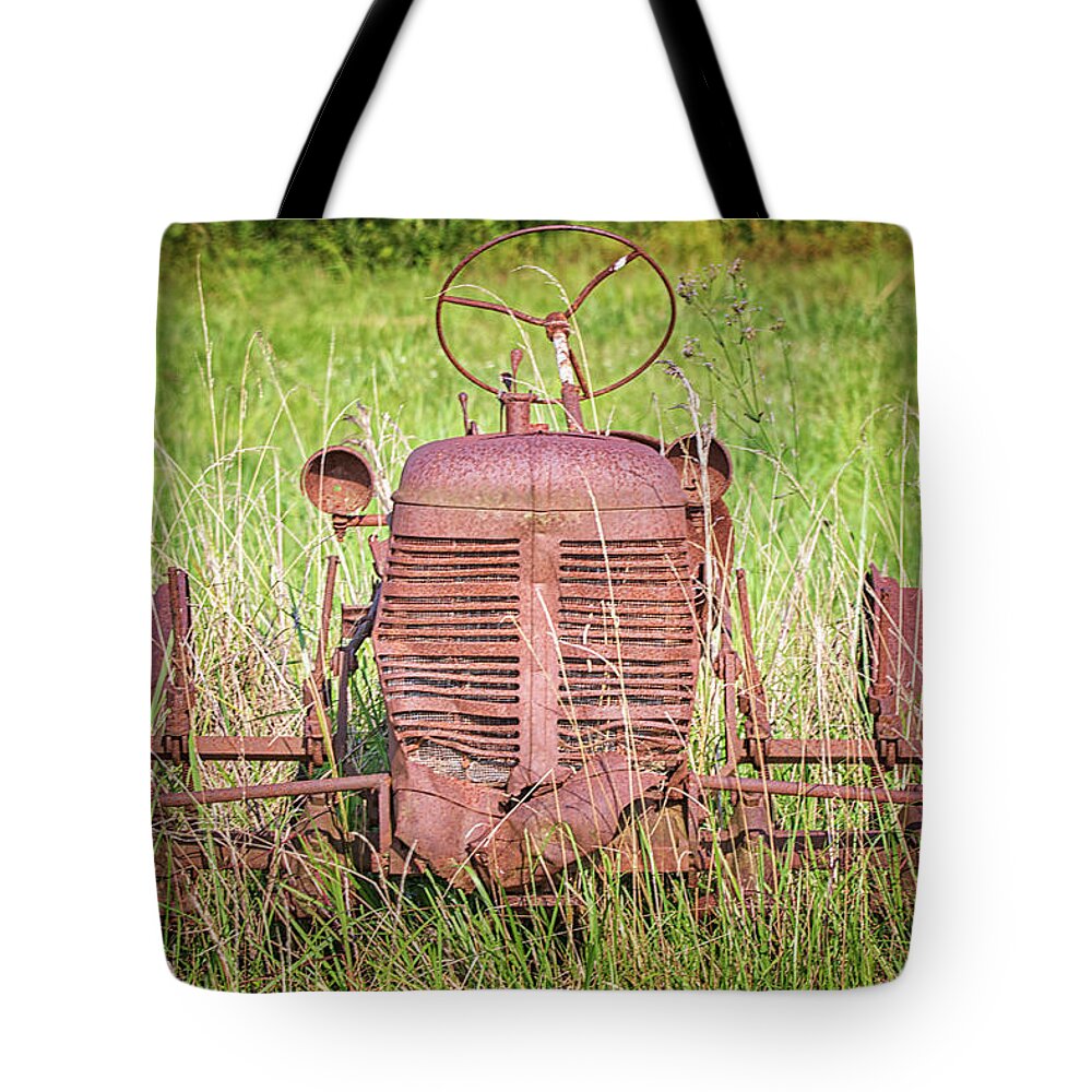 Tractor Tote Bag featuring the photograph Rusted Tractor in Pamlico County North Carolina by Bob Decker