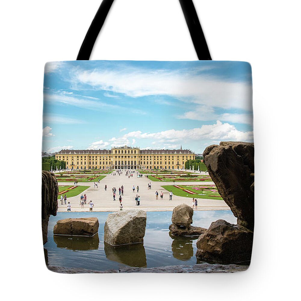Schonbrunn Palace Tote Bag featuring the photograph Schonbrunn Palace through the Rocks and Fountain by Matthew DeGrushe