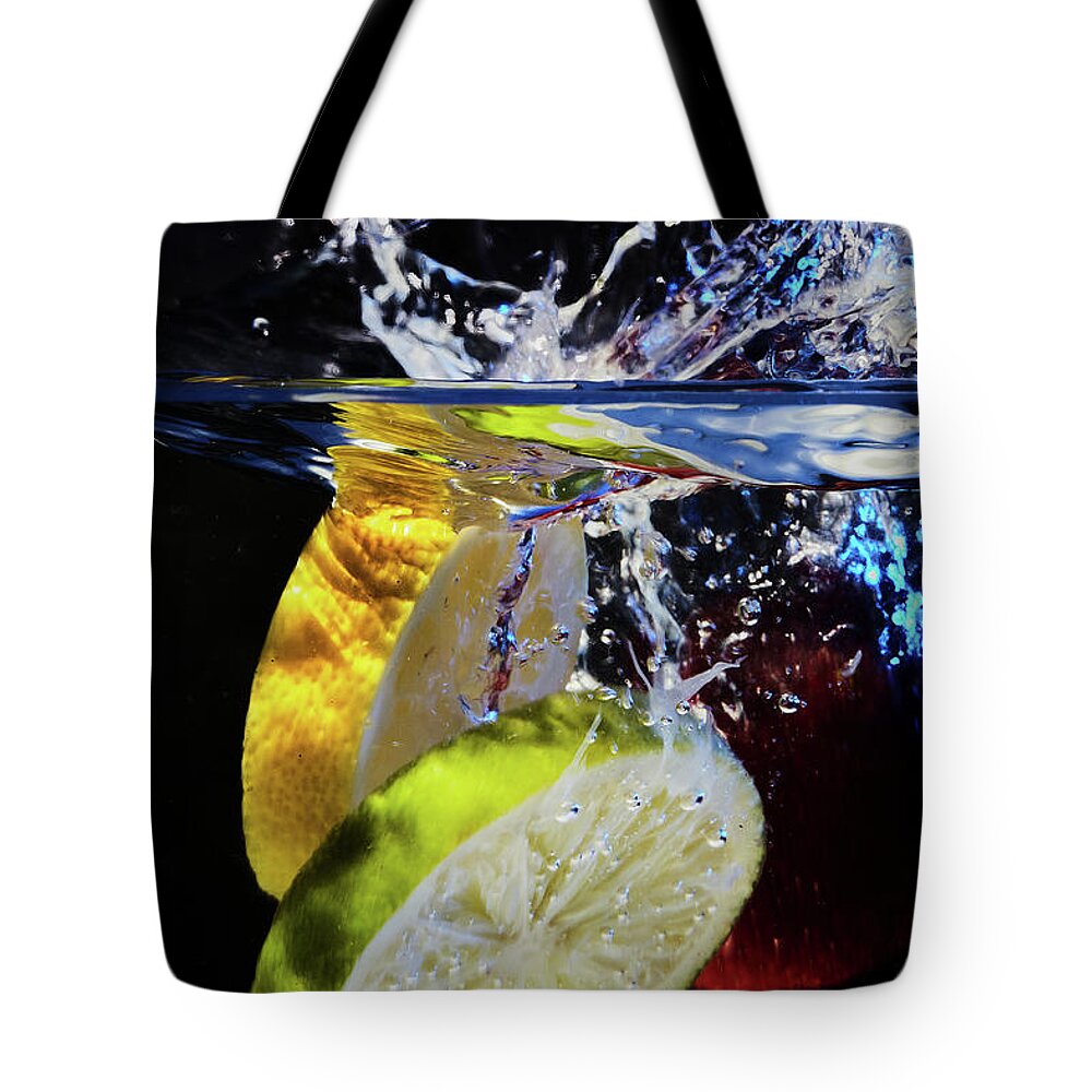 Jon Glaser Tote Bag featuring the photograph Splashing Fruit by Jon Glaser