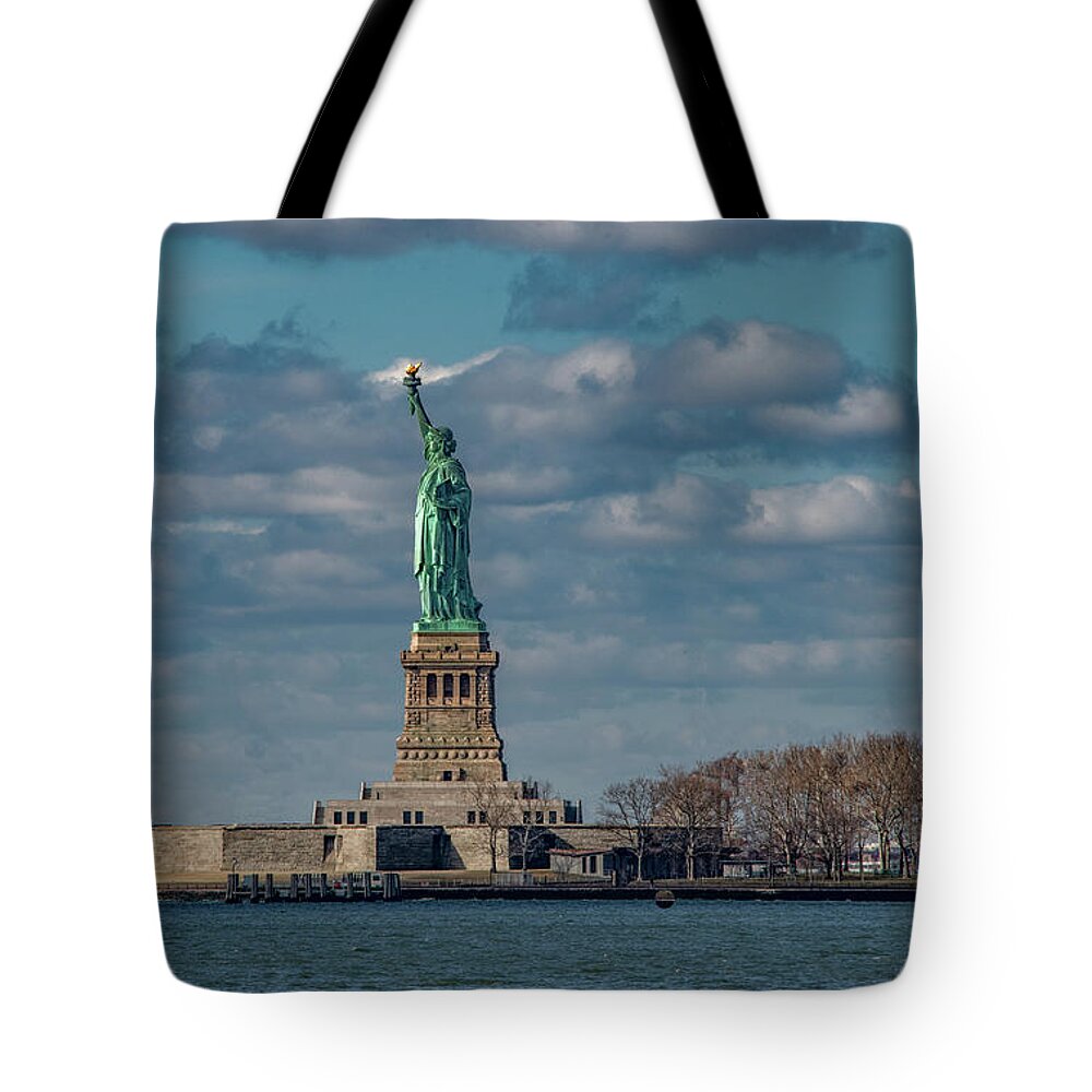 Nyc Tote Bag featuring the photograph Still She Stands Shining In The Harbor by Marcy Wielfaert