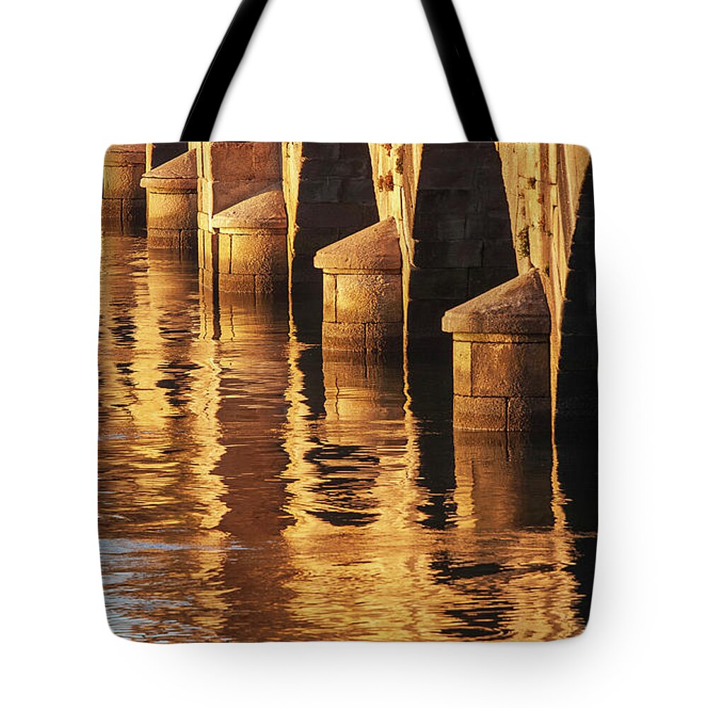 Rocks Tote Bag featuring the photograph Stone Medieval Viaduct Reflected at Sunset Golden Light Pondedeume Galicia by Pablo Avanzini