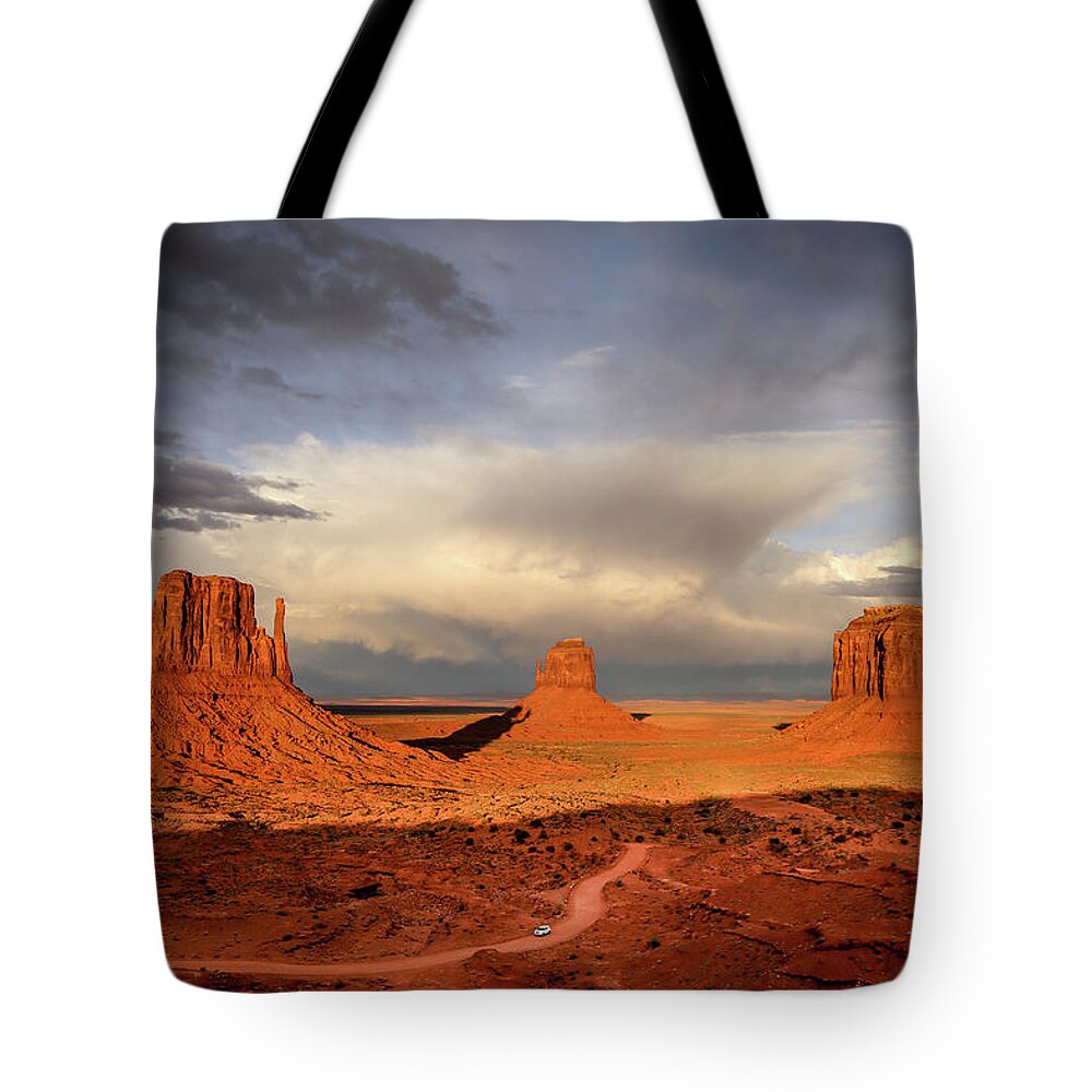 Monument Valley Tote Bag featuring the photograph Storm At Sunset At Monument Valley by Alberto Zanoni
