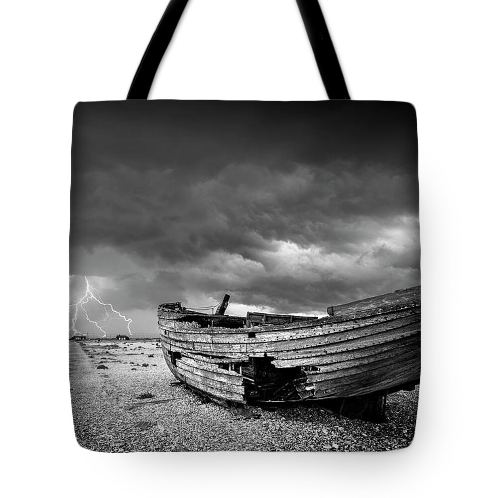 Stormy Sky Tote Bag featuring the photograph Stormy Dungeness, Wrecked boat on a shingle beach with lightning by Neale And Judith Clark