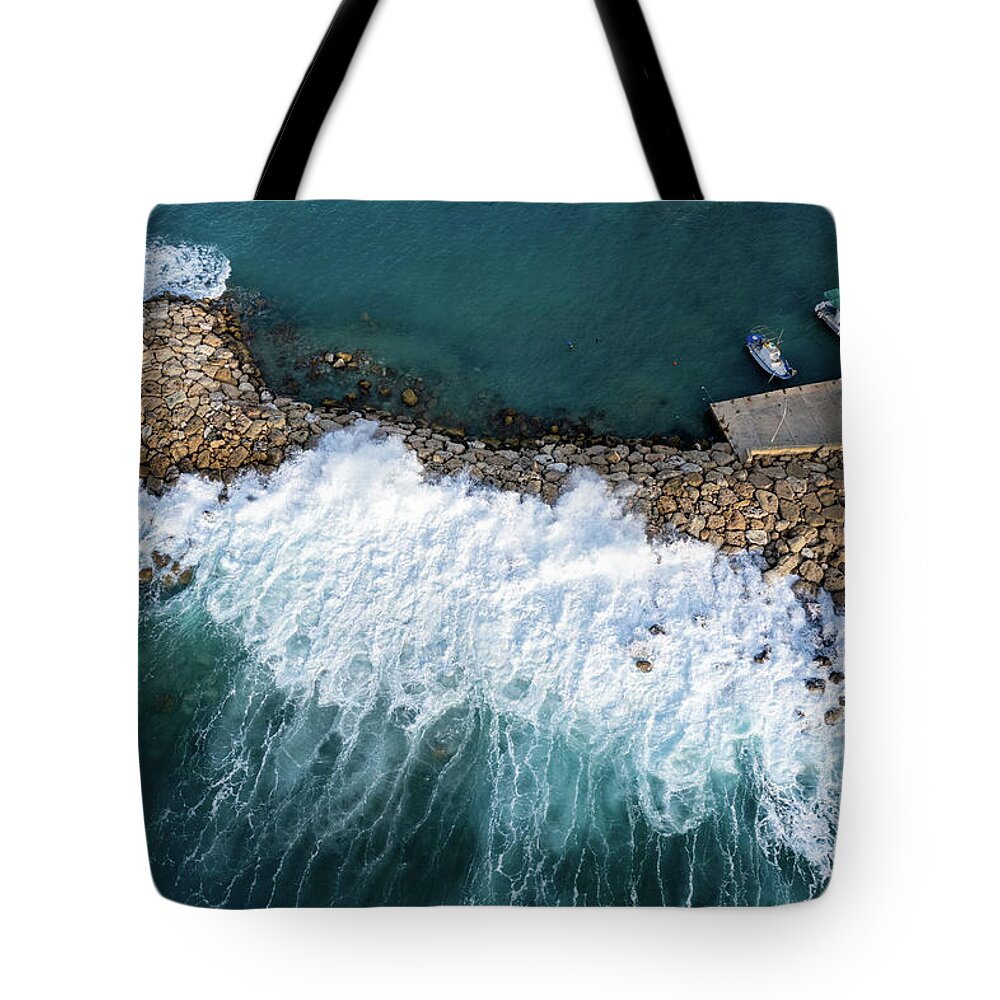 Brakewater Tote Bag featuring the photograph Stormy windy waves on the shore. Drone photography. by Michalakis Ppalis