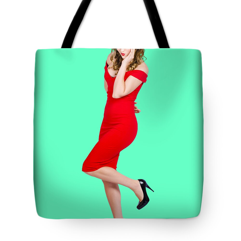 Girl Tote Bag featuring the photograph Stunning pinup girl in red rockabilly fashion by Jorgo Photography