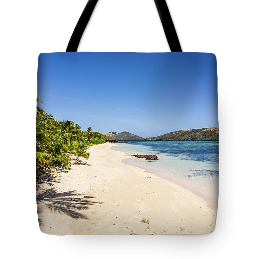 Fiji Tote Bag featuring the photograph Stunning white sand beach by the blue lagoon in the Yasawa islan by Didier Marti