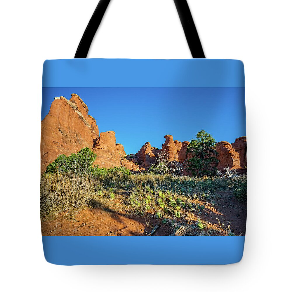 Arches National Park Tote Bag featuring the photograph Sunrise on Hoo Doos by Ron Long Ltd Photography