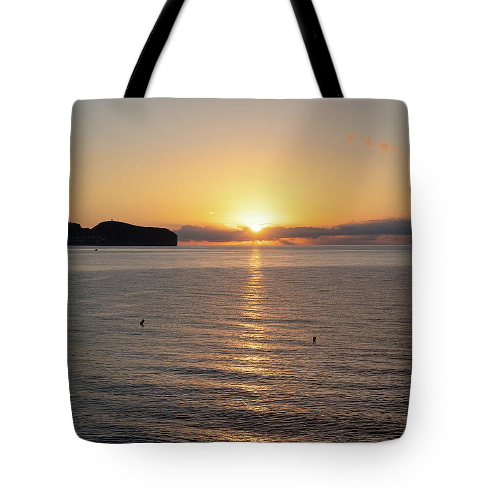Sunrise Tote Bag featuring the photograph Sunrise on the Mediterranean coast in Spain by Adriana Mueller