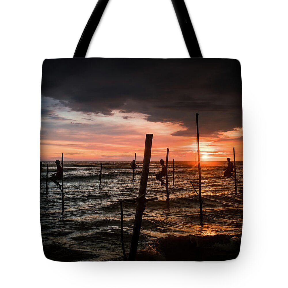 Fisherman Tote Bag featuring the photograph Sunset and Stilt Fishermen by Arj Munoz
