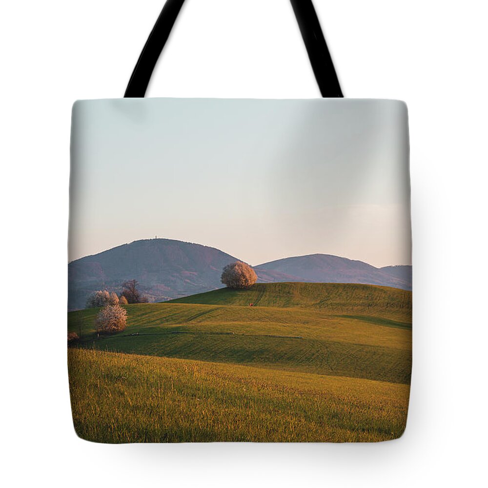 Kozlovice Tote Bag featuring the photograph Sunset on a green field of hills by Vaclav Sonnek