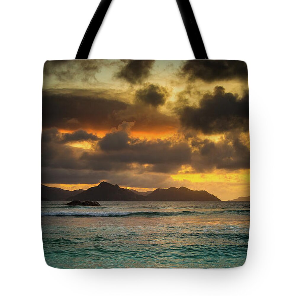 Background Tote Bag featuring the photograph Sunset on Praslin Island by Jean-Luc Farges