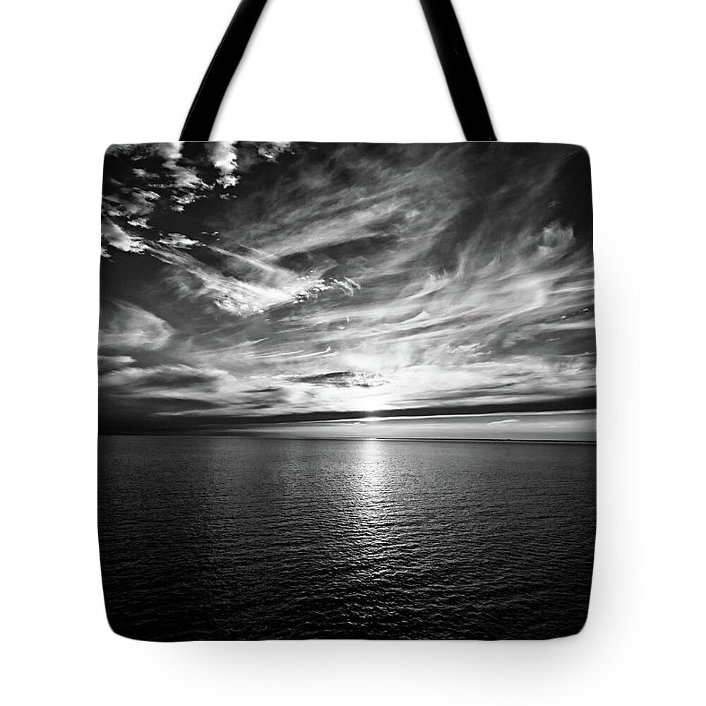 Sunset Tote Bag featuring the photograph Sunset on the horizon at sea by Bernhard Schaffer