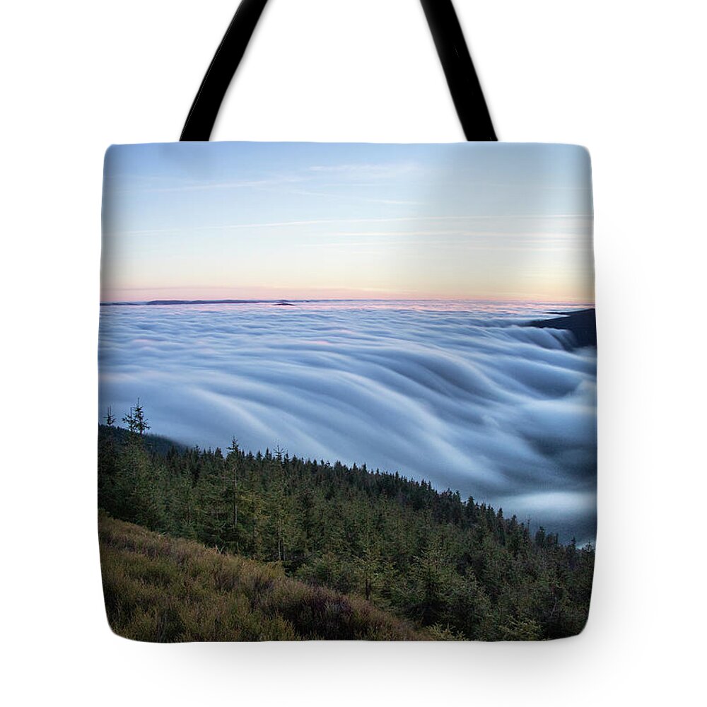 Courage Tote Bag featuring the photograph Sunset with floating blue waves of clouds by Vaclav Sonnek