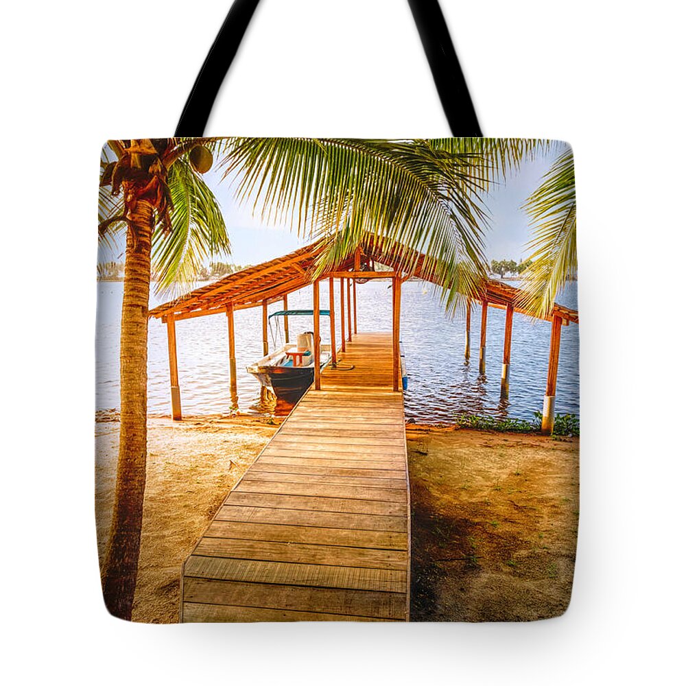 African Tote Bag featuring the photograph Swaying Palms Over the Dock by Debra and Dave Vanderlaan