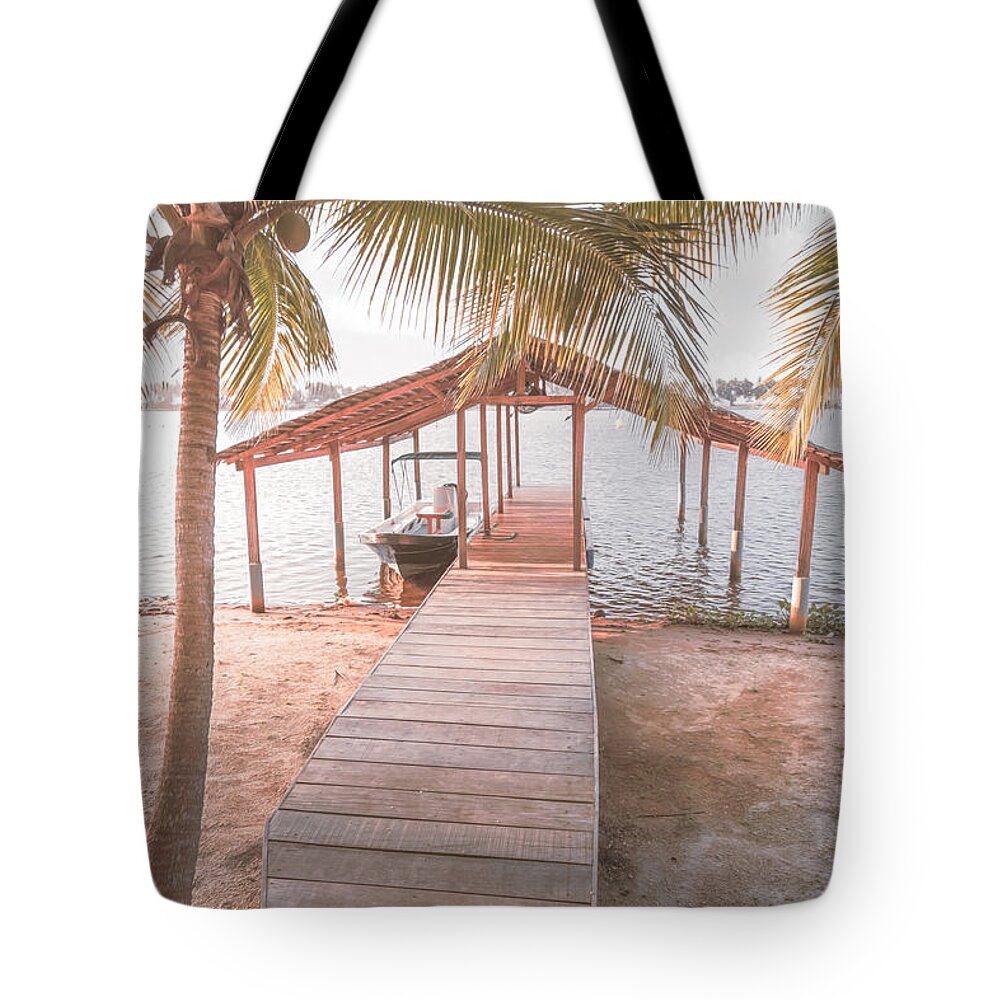 African Tote Bag featuring the photograph Swaying Palms Over the Dock in Pale Colors by Debra and Dave Vanderlaan
