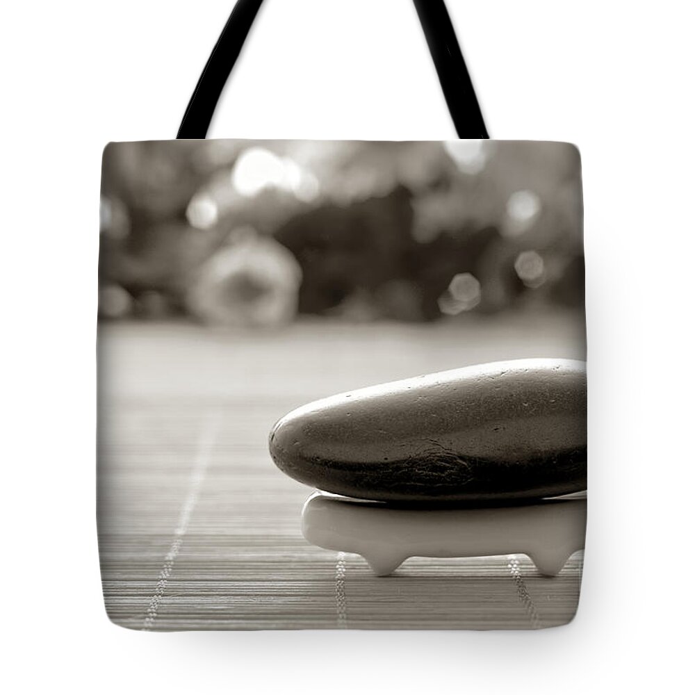 Meditative Tote Bag featuring the photograph Symbolic Zen Inspired Stone in a Spa by Olivier Le Queinec