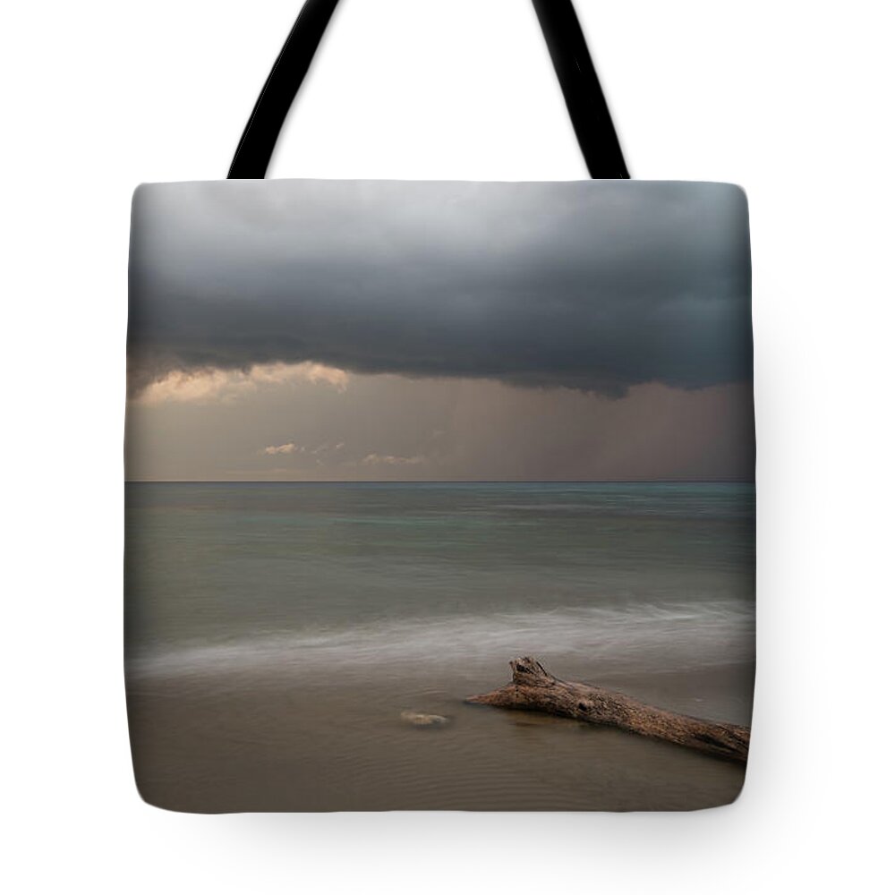 Storm Tote Bag featuring the photograph The coming of the storm from ocean by Michalakis Ppalis