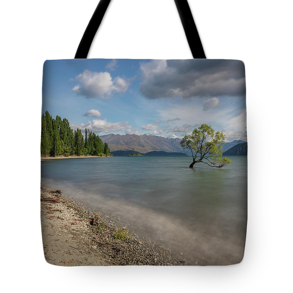 Beautiful Tote Bag featuring the photograph The famous Wanaka tree at Lake Wanaka taken with a long exposure by Anges Van der Logt