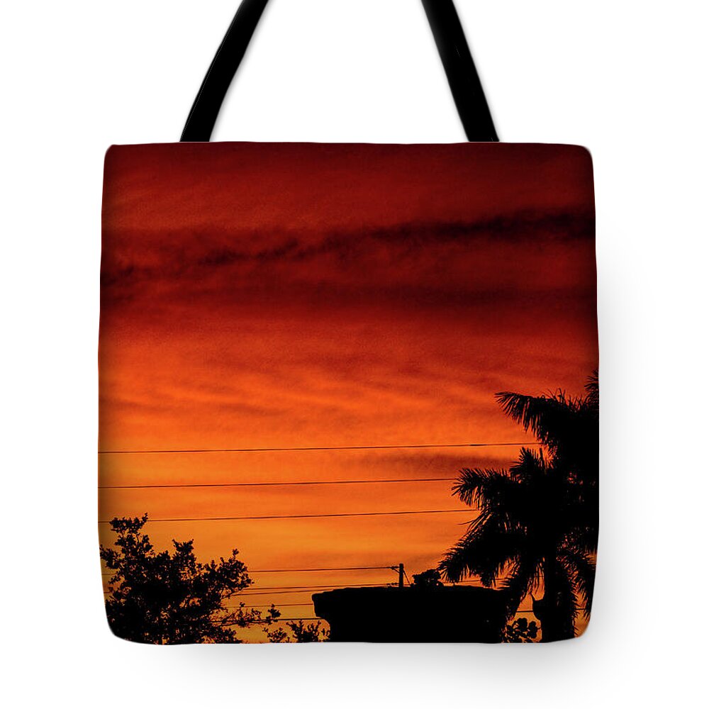 Sunset Tote Bag featuring the photograph The Fire sky by Daniel Cornell