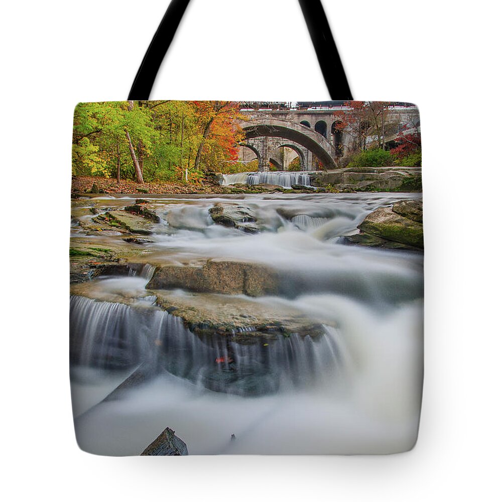 Berea Falls Tote Bag featuring the photograph The flowing river as color of the season glisten by Carolyn Hall