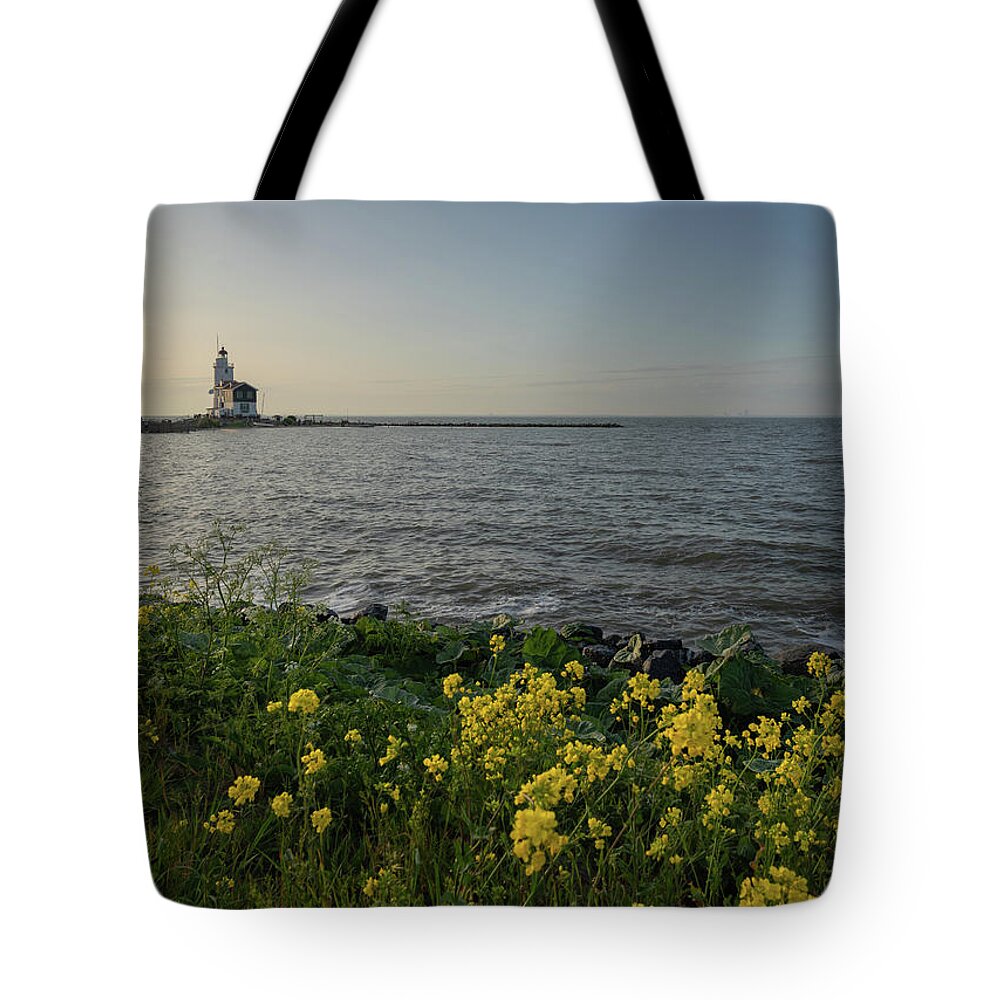 Lighthouse Tote Bag featuring the photograph The Horse of Marken, a lighthouse on the east side of the small island of Marken in the Netherlands by Anges Van der Logt