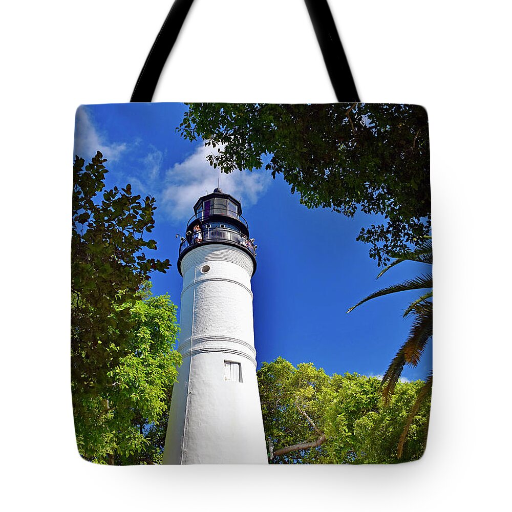 The Key Tote Bag featuring the photograph The Key West Lighthouse by Monika Salvan