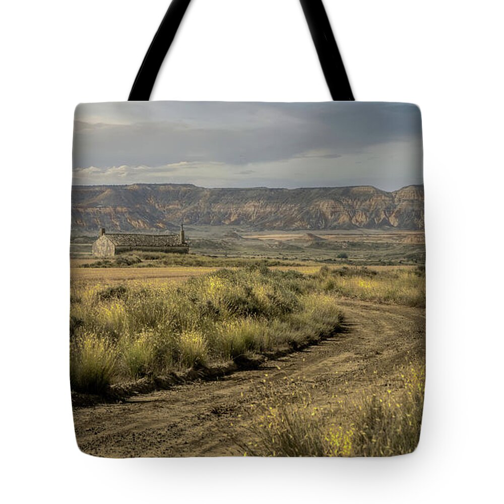 Badlands Tote Bag featuring the photograph The only house in the Bardenas Reales by Micah Offman