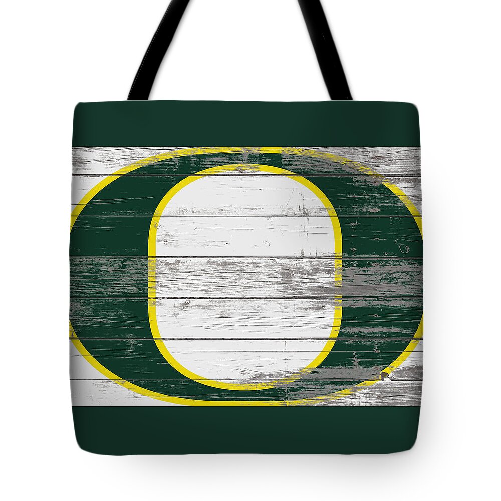 The Oregon Ducks Football Tote Bag featuring the mixed media The Oregon Ducks  by Brian Reaves