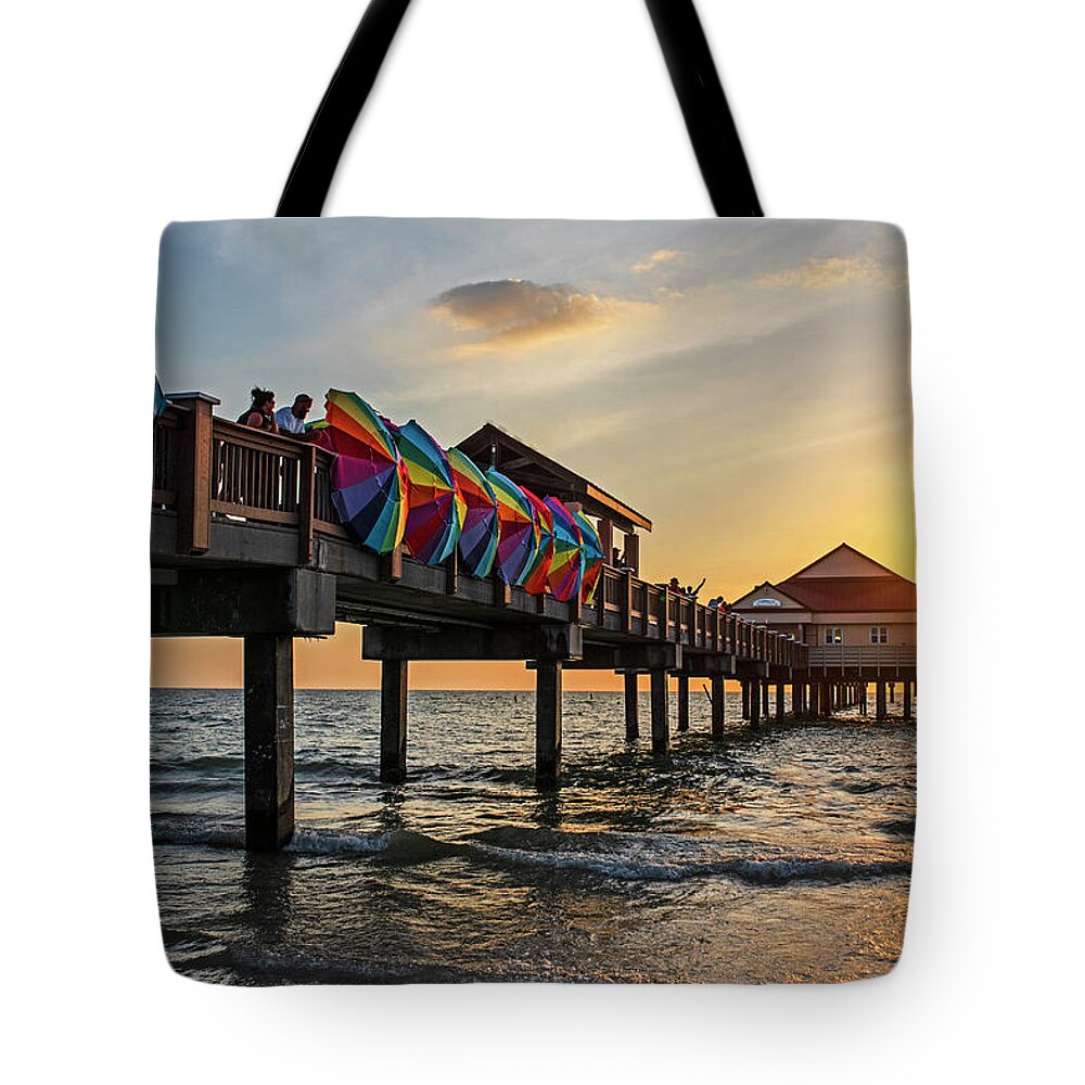 Clearwater Tote Bag featuring the photograph The Sunset at the Clearwater Beach Pier Clearwater Florida Beach Umbrellas by Toby McGuire
