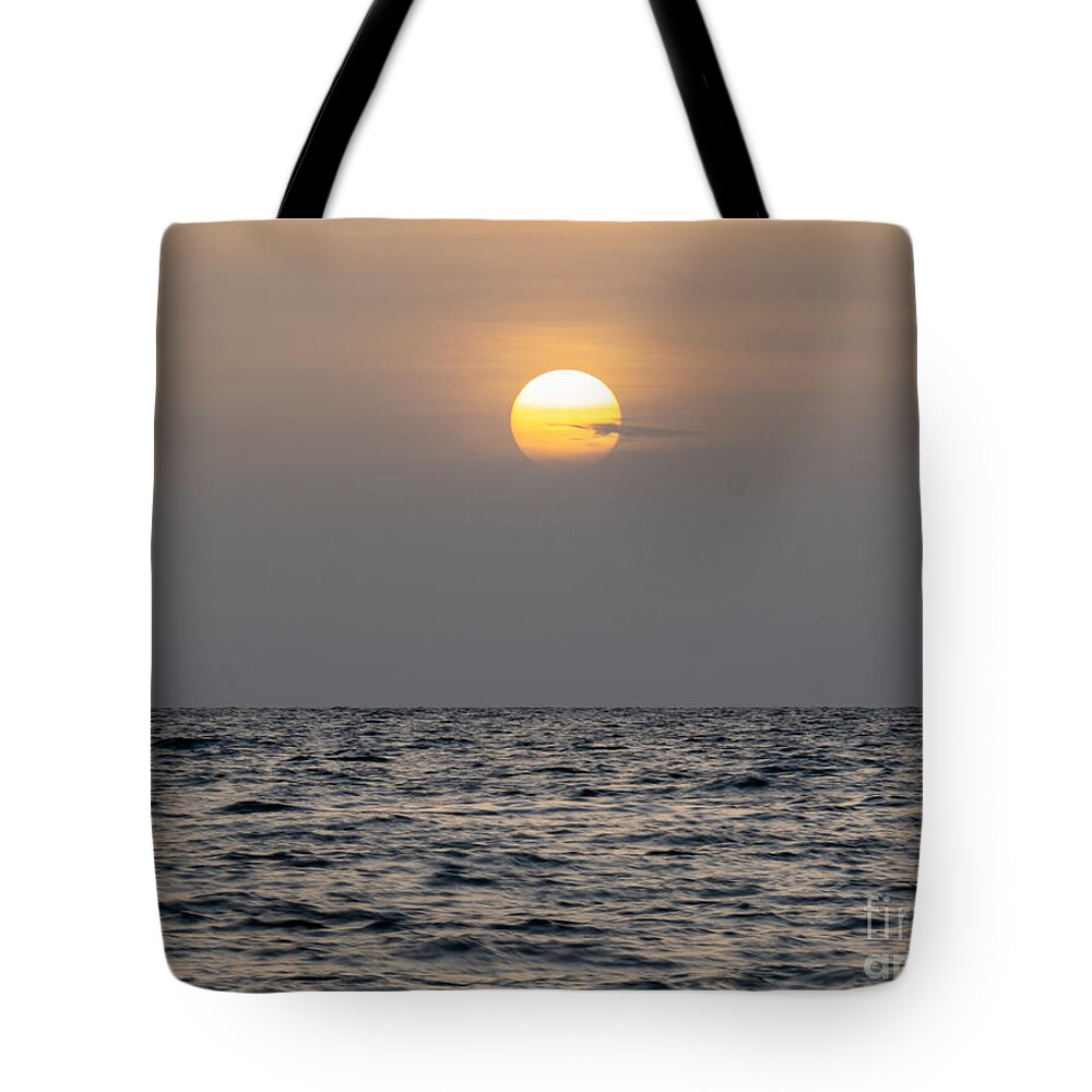 Sunset Tote Bag featuring the photograph The Sunset Through the Sahara Dust Plume Off the Florida Gulf Coast by L Bosco